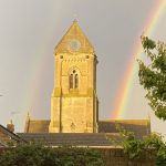 Rainbow in sky and church